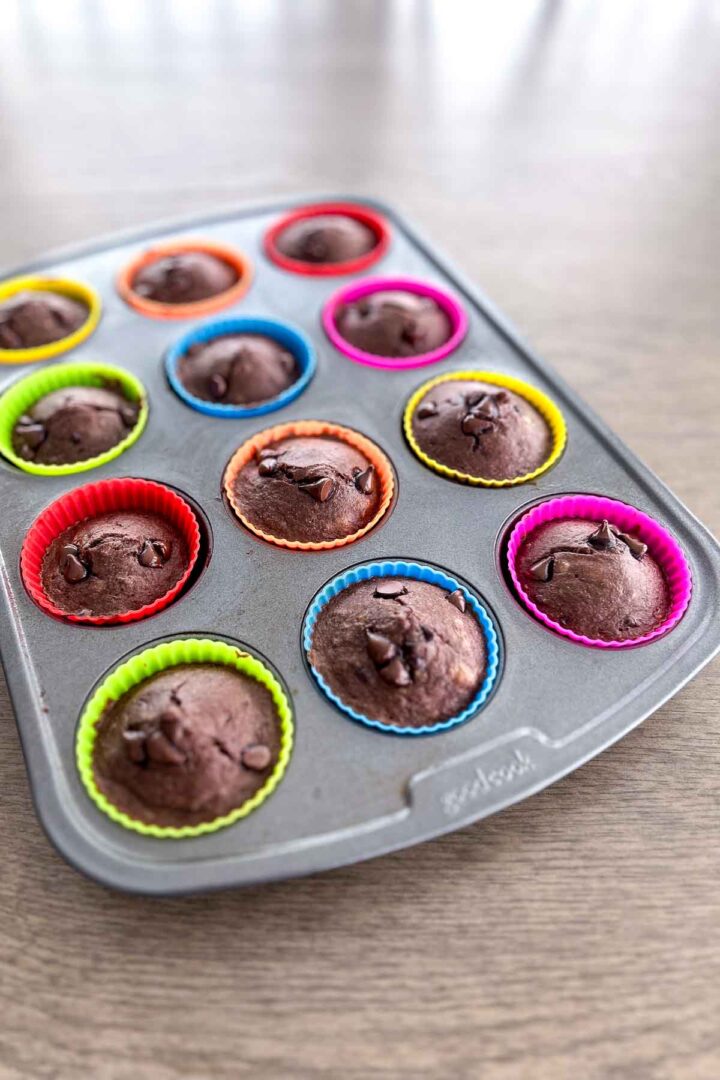 cooked chocolate banana muffins in a muffin tin
