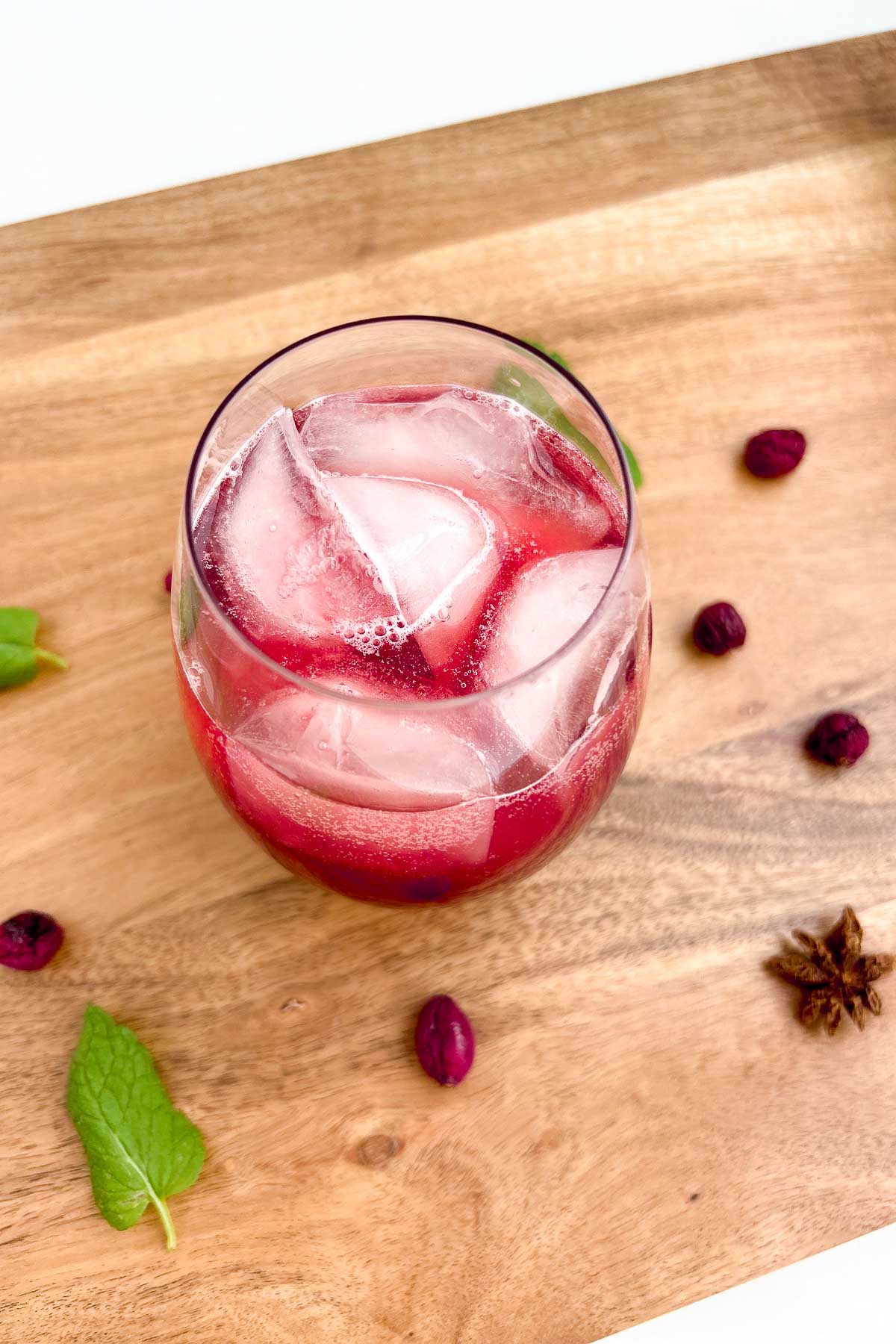 Wine glass with Sleepy Girl Mocktail with dried berries and garnishes